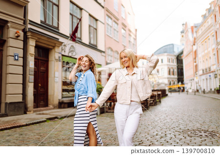 Female tourists in bright dress enjoys sights of city on sunny day. Concept of lifestyle, fashion. 139700810