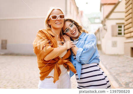 Two young women posing on the street background. Concept of lifestyle, fashion, travel. 139700820