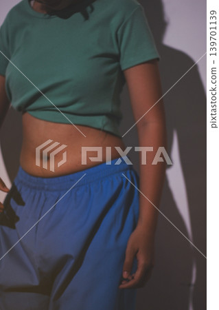 Overweight woman body with hands touching belly fat 139701139