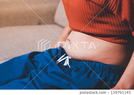 Overweight woman body with hands touching belly fat Overweight woman body with hands touching belly fat 139701145
