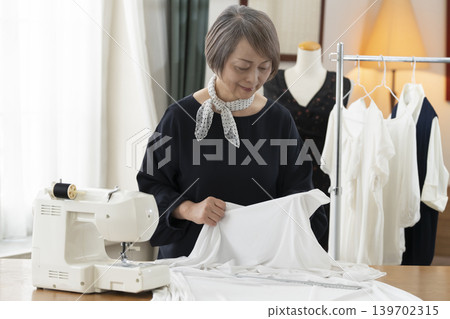Senior female designers create clothes in their atelier. Senior female designers create clothes in their atelier. 139702315