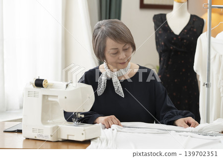 Senior female designers create clothes in their atelier. Senior female designers create clothes in their atelier. 139702351