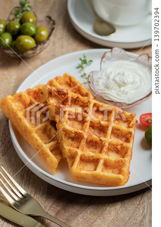 Crunchy waffle fries with sour cream dip served in a basket Crunchy waffle fries with sour cream dip served in a basket 139702394