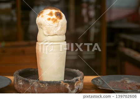 Famous Turkish dish testi kebab or kebab in pot, stew of meat and vegetables in clay pot with bread lid Famous Turkish dish testi kebab or kebab in pot, stew of meat and vegetables in clay pot with bread lid 139702606