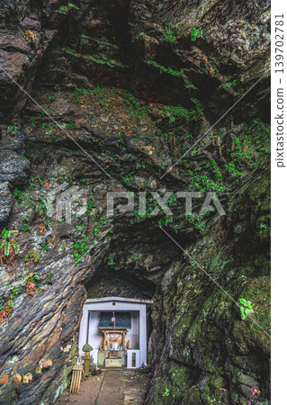 The mystical prayer space of Yakushima's Yahazudake Shrine, nestled in a rocky cave. The mystical prayer space of Yakushima's Yahazudake Shrine, nestled in a rocky cave. 139702781