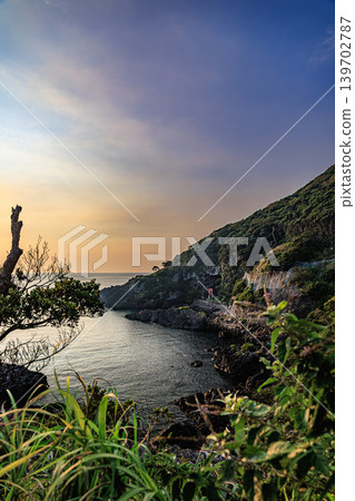 A tranquil coastal landscape overlooking Yahazudake Shrine on Yakushima Island. A tranquil coastal landscape overlooking Yahazudake Shrine on Yakushima Island. 139702787