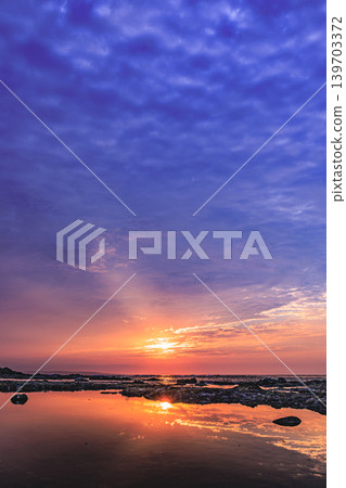 The dawn at Harutahama Beach in Yakushima, bathed in purple and orange light. The dawn at Harutahama Beach in Yakushima, bathed in purple and orange light. 139703372