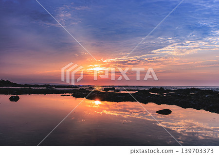 A quiet morning at Harutahama Beach in Yakushima, where the sunrise is reflected on the water's surface. A quiet morning at Harutahama Beach in Yakushima, where the sunrise is reflected on the water's surface. 139703373