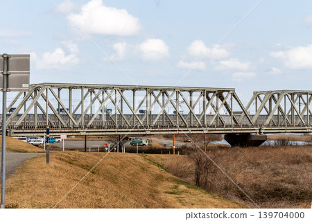 A railway bridge running under a blue sky and a riverside landscape: Japan's transportation infrastructure A railway bridge running under a blue sky and a riverside landscape: Japan's transportation infrastructure 139704000