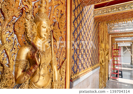 High relief guardian figure temple door Prasat Thong Kham Kanchanaphisek golden palace Wat Chantharam, ThaSung UthaiThani Thailand gilded ornament mirrored mosaic. High relief guardian figure temple door Prasat Thong Kham Kanchanaphisek golden palace Wat Chantharam, ThaSung UthaiThani Thailand gilded ornament mirrored mosaic. 139704314