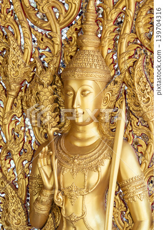 Close view ornate temple door golden thepphanom figure high relief layered carving sacred Thai ornament craftsmanship. Close view ornate temple door golden thepphanom figure high relief layered carving sacred Thai ornament craftsmanship. 139704316