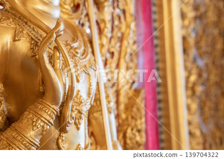 Close view ornate temple door golden thepphanom figure high relief layered carving sacred Thai ornament craftsmanship. Close view ornate temple door golden thepphanom figure high relief layered carving sacred Thai ornament craftsmanship. 139704322