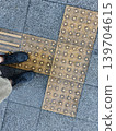 A woman's wet shoes and sidewalk in the pouring rain 139704615