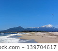 Snow-covered Mt. Daisen, the Sea of Japan, and a paraglider 139704617