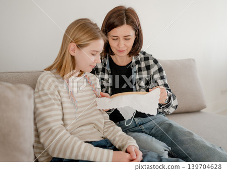 Little Girl Learns Embroidery On A Hoop With Mom As A Family Hobby And Time Together 139704628