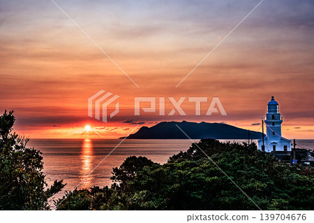 Yakushima Lighthouse bathed in the setting sun and the silhouette of Kuchinoerabu Island 139704676