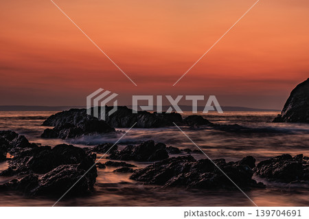 Pillow lava formations spread across the Tashiro coast of Yakushima Island, creating a seascape bathed in the colors of dawn. Pillow lava formations spread across the Tashiro coast of Yakushima Island, creating a seascape bathed in the colors of dawn. 139704691