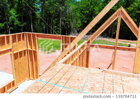 Construction process of house frame in wooded area 139704711
