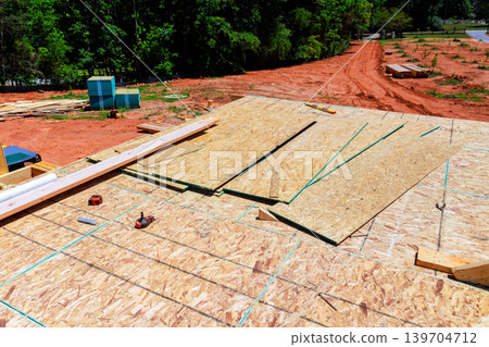 Construction work takes place on new unfinished building site in rural area 139704712