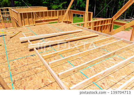 Construction site wooden beams framework being built in rural area 139704713