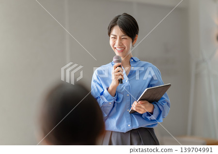 A woman talking with a microphone A woman talking with a microphone 139704991