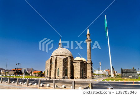 Exterior view of the historic Al Anbariya Mosque with its unique stone dome and minaret under a clear sky in Madinah, Saudi Arabia Exterior view of the historic Al Anbariya Mosque with its unique stone dome and minaret under a clear sky in Madinah, Saudi Arabia 139705046
