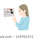 Woman checking on the intercom monitor; no wires. 139705253