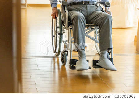 A senior man in a wheelchair and a woman caring for him. A senior man in a wheelchair and a woman caring for him. 139705965