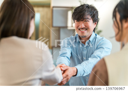 Businessmen shaking hands to greet, introduce themselves and conclude a contract in a corporate office 139706967