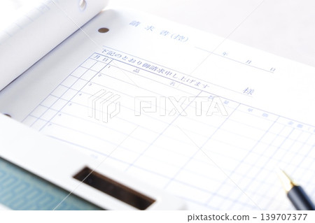Invoice - An image of a business scene where an invoice is being created for a business partner. Invoice - An image of a business scene where an invoice is being created for a business partner. 139707377