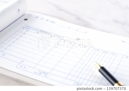 Invoice - An image of a business scene where an invoice is being created for a business partner. Invoice - An image of a business scene where an invoice is being created for a business partner. 139707378