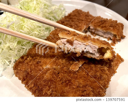 Pork fillet cutlet cross-section, served with shredded cabbage. Pork fillet cutlet cross-section, served with shredded cabbage. 139707591