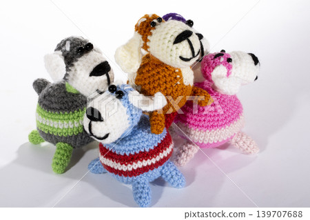 Knitted woolen dogs on a white background Knitted woolen dogs on a white background 139707688