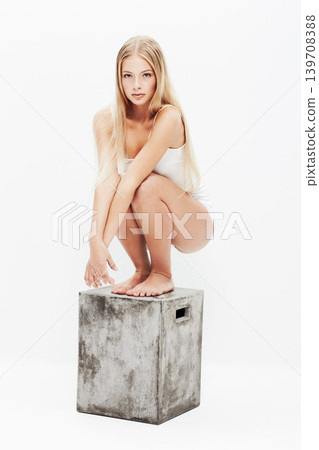 Young woman, portrait and skin in underwear, white background on crate, grooming and wellness. Clean, health and female model in clothes, dermatology body glow and backdrop with face confidence Young woman, portrait and skin in underwear, white background on crate, grooming and wellness. Clean, health and female model in clothes, dermatology body glow and backdrop with face confidence 139708388