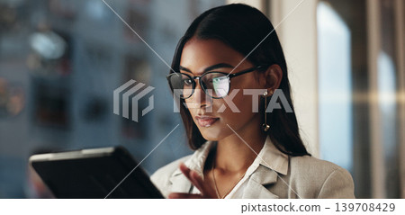 Tablet, reflection and businesswoman with glasses, overtime in office with planning and scroll on social media. Vision, research and woman typing email, late at night work on future ideas for agency. Tablet, reflection and businesswoman with glasses, overtime in office with planning and scroll on social media. Vision, research and woman typing email, late at night work on future ideas for agency. 139708429
