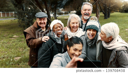 Nature, selfie and senior friends with woman while walking in outdoor garden for fresh air. Diversity, happy and group of elderly people in retirement taking picture with young female person in park. 139708438