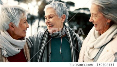 Talking, laughing and senior woman friends outdoor in a park together for bonding during retirement. Happy, smile and funny with a group of elderly people chatting in a garden for humor or fun 139708531