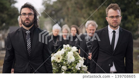 Pallbearers, men and walking with coffin at graveyard ceremony outdoor at burial place. Death, grief and group of people with casket at cemetery for funeral and family service while mourning at event Pallbearers, men and walking with coffin at graveyard ceremony outdoor at burial place. Death, grief and group of people with casket at cemetery for funeral and family service while mourning at event 139708605