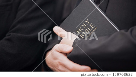 Bible, funeral and hands closeup of a priest for religion, sad and mourning event in church. Faith, male person and spiritual passage with worship and book for grief with support and condolences Bible, funeral and hands closeup of a priest for religion, sad and mourning event in church. Faith, male person and spiritual passage with worship and book for grief with support and condolences 139708622