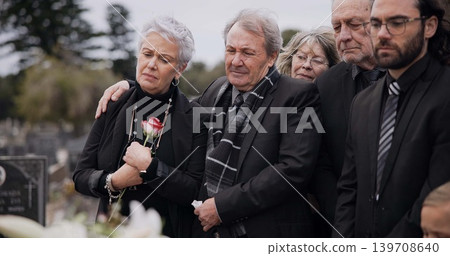 Death, funeral and elderly couple sad together at pain or grief for death and loss during a ceremony. Rose, support or empathy with a senior man and woman feeling depression at a memorial service Death, funeral and elderly couple sad together at pain or grief for death and loss during a ceremony. Rose, support or empathy with a senior man and woman feeling depression at a memorial service 139708640