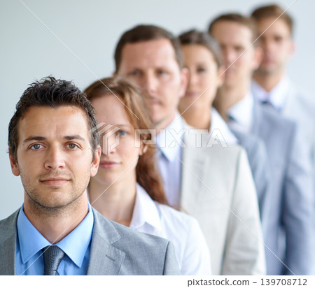 Man, portrait and serious for interview, finance career and ready for selection process. Worker, corporate accountant in suit or professional in workplace, colleagues in background and confident 139708712