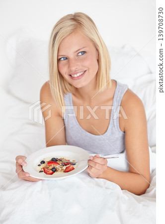 Woman, thinking and breakfast in bed, house and wake up for morning hospitality or accommodation. Relax, cereal and holiday with young person in bedroom with fruit, weekend and comfortable with food 139708730