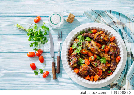 Roasted chicken drumsticks with tomatoes in a dish 139708830