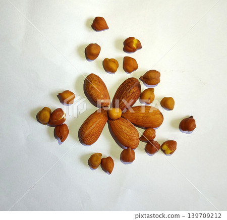 Healthy mix of almonds and chickpeas scattered on white. 139709212
