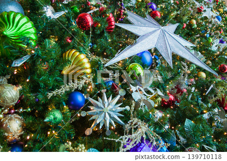 Christmas tree decorations sparkling with snowflake and star ornaments in Florida Christmas tree decorations sparkling with snowflake and star ornaments in Florida 139710118
