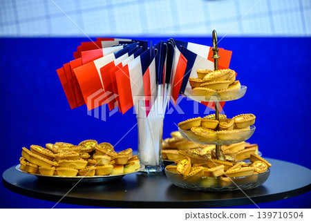 French flags with bite-size pastries on catering table 139710504