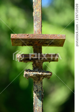 Rusty Metal Fence Detail with Green Bokeh Background Rusty Metal Fence Detail with Green Bokeh Background 139710509