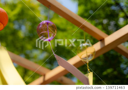 Wind chimes swaying in the fresh green of summer Wind chimes swaying in the fresh green of summer 139711463