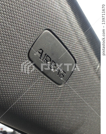 Textured black car seat with raised airbag label Textured black car seat with raised airbag label 139711670