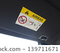 Airbag warning label mounted inside car roof 139711671